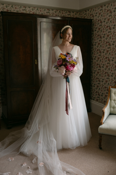 Elegant white wedding dress with bridal bouquet